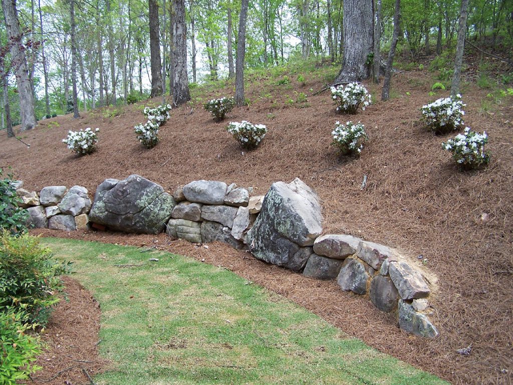An out cropped boulder wall around the park