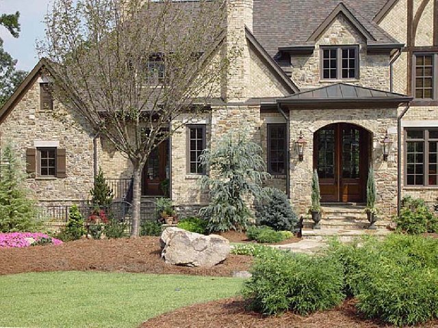 a house with medium stack stone exterior walls