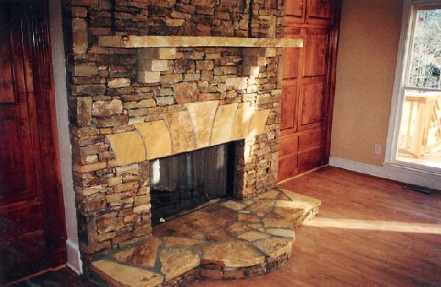 Medium Stack stone idoor fireplace with Cut Stone Mantel and Cut Arch