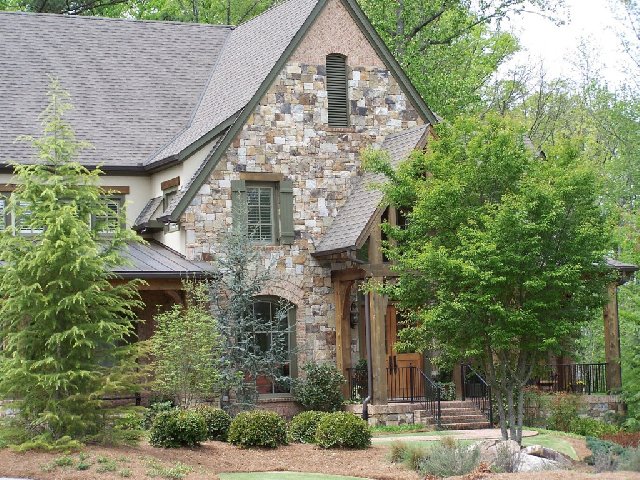 A house with Thick Ashlar Fieldstone Dry Stacked stone exterior walls