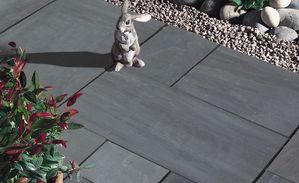 A rabbit figurine standing on the natural stone flooring