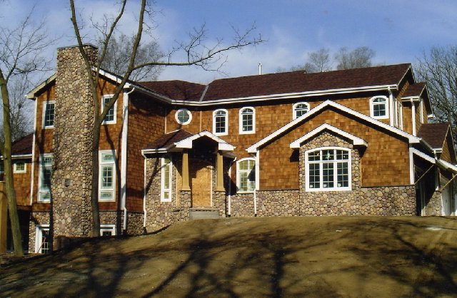 A picture of the house with earth blend river rock